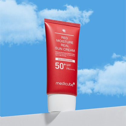 medicube Red Moisture Real Sun Cream 50ml in red tube with daily protection against sun damage on blue sky background