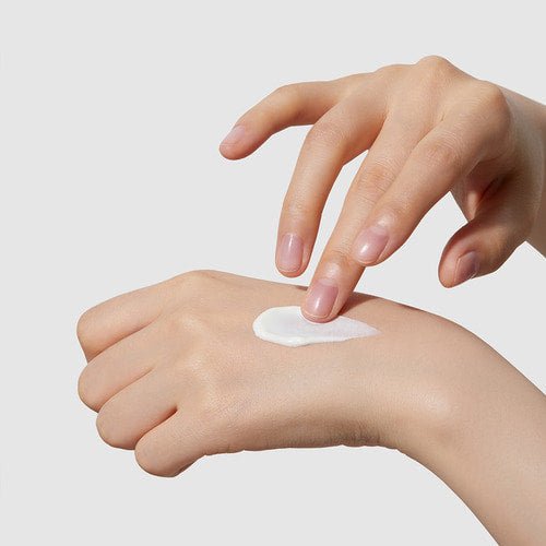 medicube Red Moisture Real Sun Cream 50ml applied on hand demonstrating daily protection skincare benefits