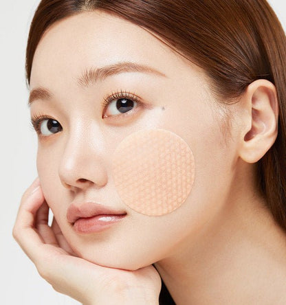 model with smooth skin applying medicube Red Succinic Acid Peeling Pad 155g/70pads on cheek for acne relief