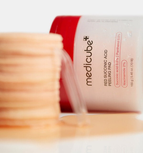 medicube Red Succinic Acid Peeling Pad 155g/70pads container with stacked peeling pads for acne relief treatment