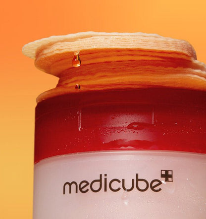 medicube Red Succinic Acid Peeling Pad 155g/70pads with textured pads stacked on container for acne relief care
