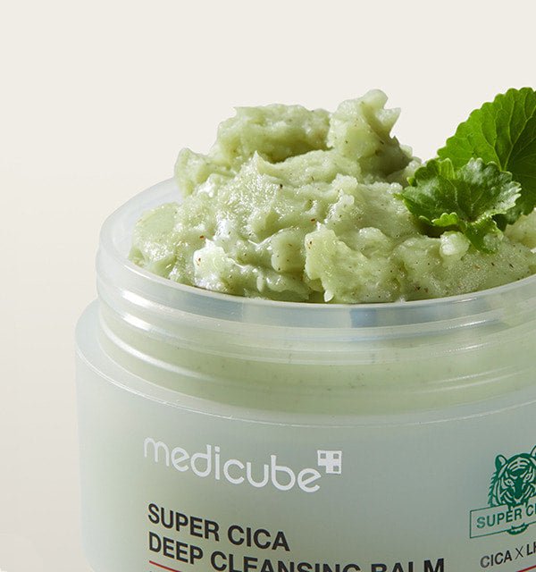medicube Super Cica Deep Cleansing Balm 100ml in jar with textured green balm and fresh leaf for thorough cleansing