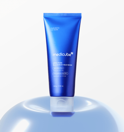 medicube Zero Pore Blackhead Mud Mask 100g in blue tube standing on glossy surface for deep cleansing care