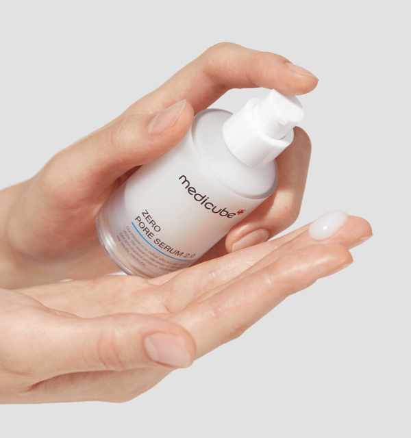 medicube Zero Pore Serum 2.0 37ml in white bottle dispensing pore-tightening serum onto hand