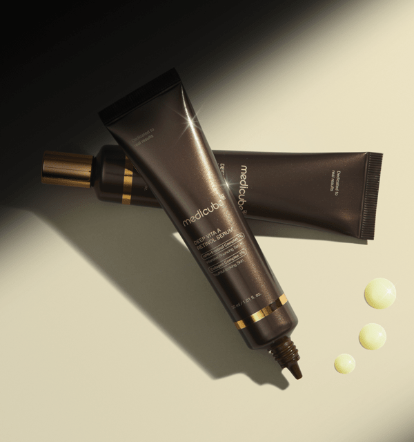 medicube Deep Vita A Retinol Serum 30ml dark brown tubes with golden accents and serum drops for collagen boost benefits