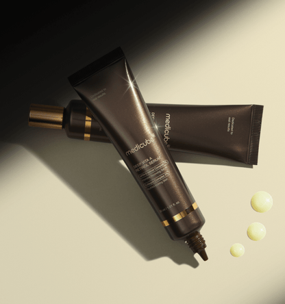 medicube Deep Vita A Retinol Serum 30ml dark brown tubes with golden accents and serum drops for collagen boost benefits