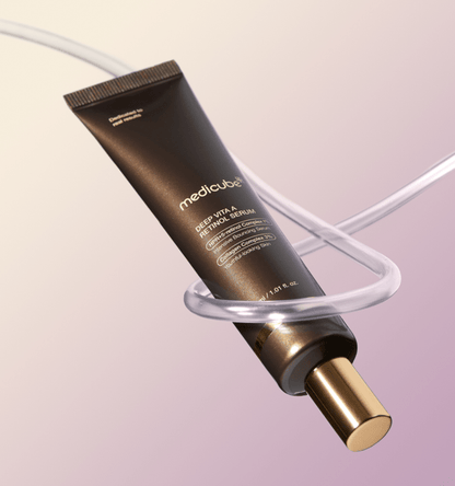 medicube Deep Vita A Retinol Serum 30ml in dark brown tube with gold cap surrounded by clear curved tubing