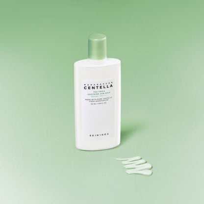 White bottle of soothing sun milk with green cap and product swatch on pale green background