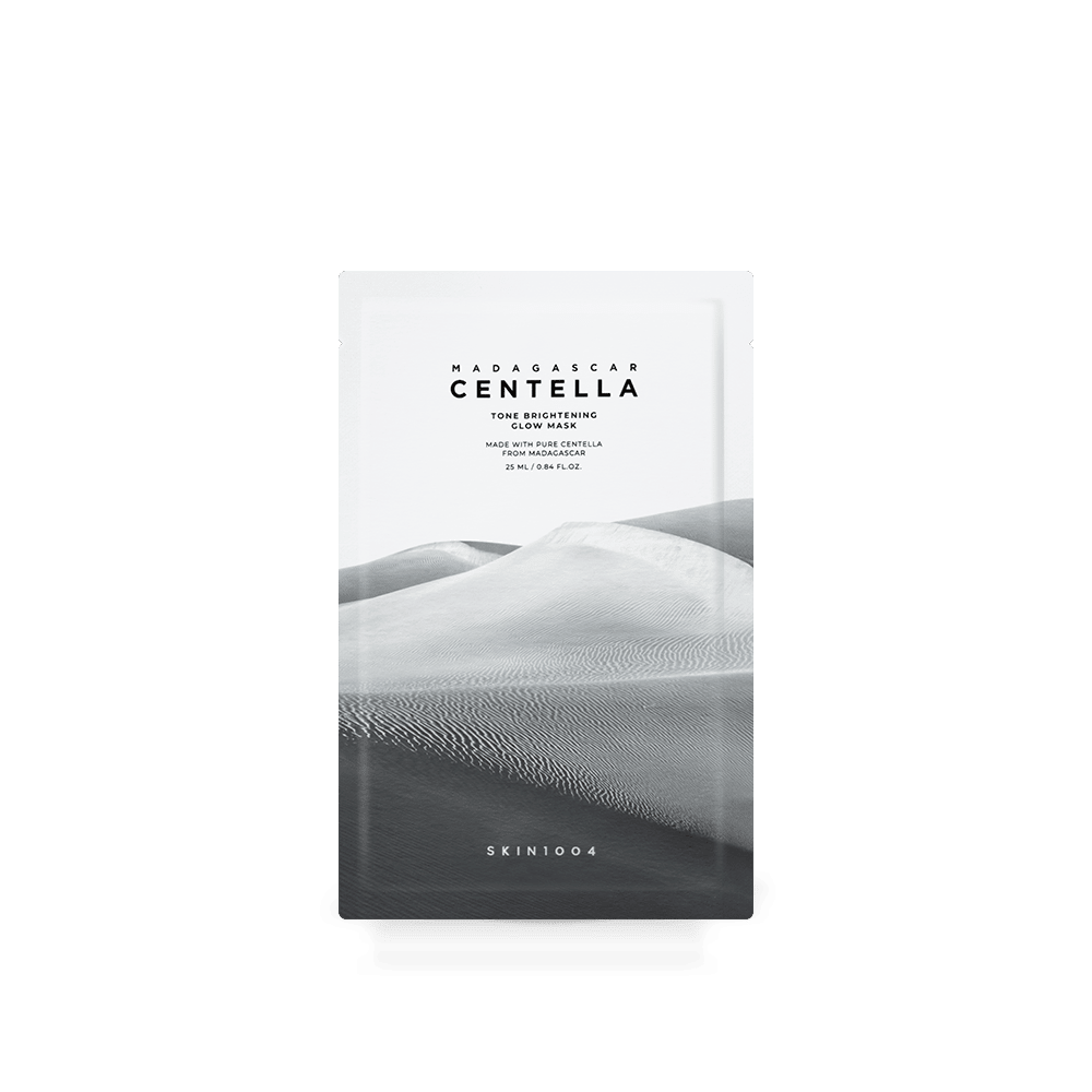 Minimalist white sachet of brightening glow mask with grayscale desert dunes background and simple black text design