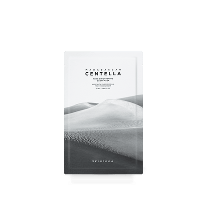 Minimalist white sachet of brightening glow mask with grayscale desert dunes background and simple black text design