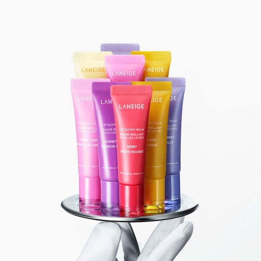 LANEIGE Lip Glowy Balm 10g in assorted colorful tubes arranged on reflective surface with rich moisture formula