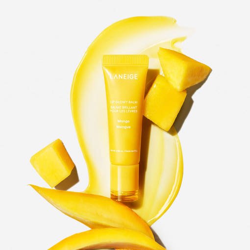 LANEIGE Lip Glowy Balm 10g in yellow tube with rich moisture surrounded by fresh mango pieces and balm swatch