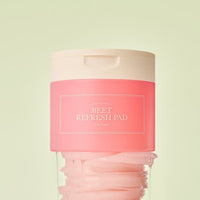 Pink container of beet refresh pads for long-lasting hydration with a soft beige lid against pale background