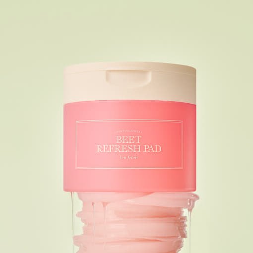 Pink container of beet refresh pads for long-lasting hydration with a soft beige lid against pale background