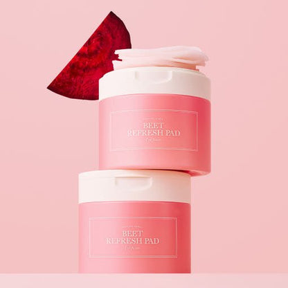 Two pink jars of beet refresh pads stacked with a fresh beet slice against a soft pink background