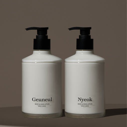 Two minimalist white lotion bottles with black pump tops labeled Geuneul and Nyeok on brown background