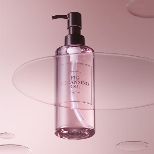 Transparent pink bottle of gentle cleansing oil with black pump on soft pink background with floating acrylic sheets