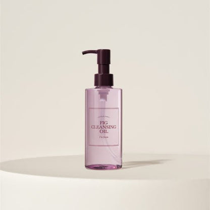 Transparent pink pump bottle of gentle cleansing oil displayed on neutral beige background with soft shadow beneath