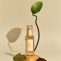 Glass pump bottle of hydrating pear serum with natural leaf and organic elements on a neutral background