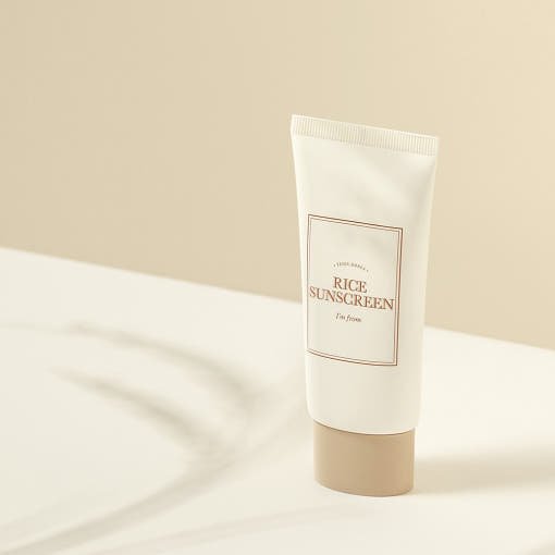 Minimalist beige tube of high protection rice sunscreen with SPF50+ on soft neutral background