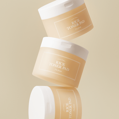 Three beige jars of hydrating rice toner pads with white lids stacked against a neutral background