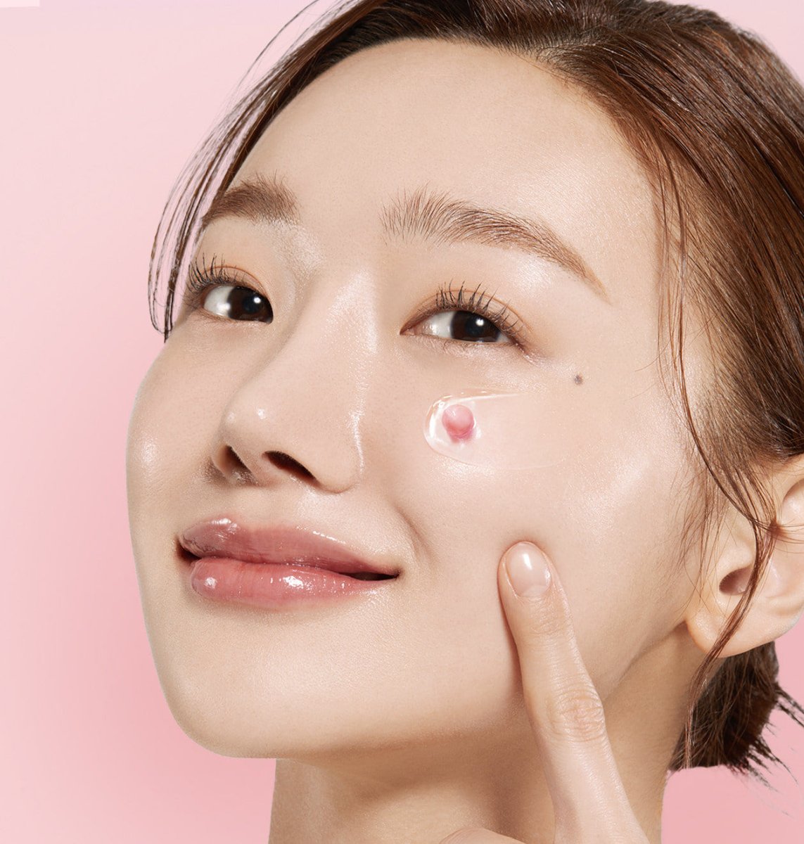 medicube PDRN Pink Collagen Capsule Cream 55ml applied on cheek showing radiant, glowing skin with light pink capsule cream texture