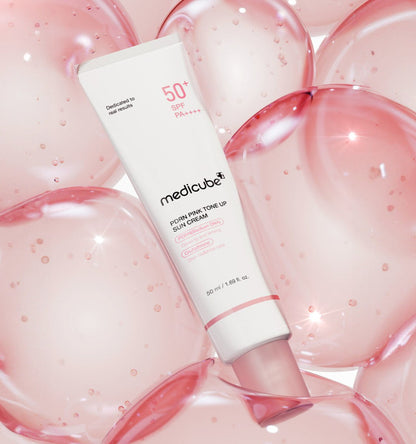medicube PDRN Pink Tone Up Sun Cream 50ml tube with high SPF surrounded by glossy pink gel bubbles