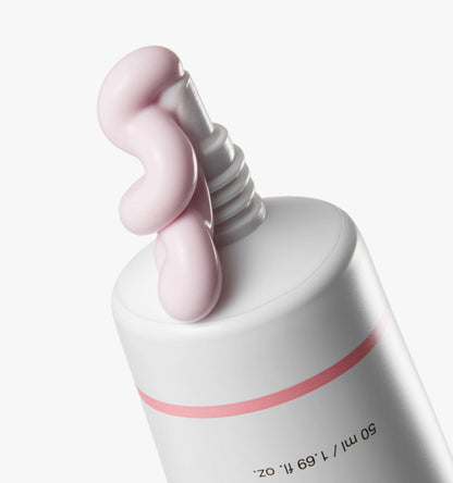 medicube PDRN Pink Tone Up Sun Cream 50ml with pale pink cream squeezed from white tube against white background