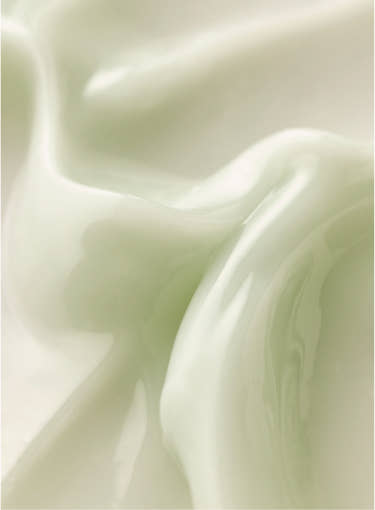 Close-up of smooth, creamy serum texture with light, translucent appearance showcasing brightening skincare benefit