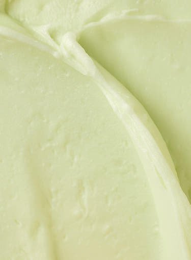 Smooth creamy swatch of pale green matte sun stick texture emphasizing strong protection and moisturizing finish