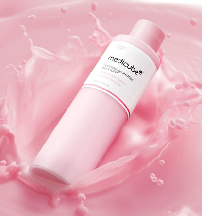 medicube PDRN Pink Niacinamide Milky Toner 150ml bottle surrounded by pink milky splash for hydration boost