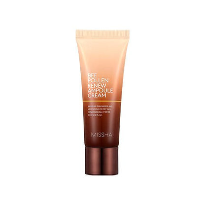 Sleek tube of nourishing Bee Pollen Renew Ampoule Cream in gradient peach and brown packaging with bronze cap on white background