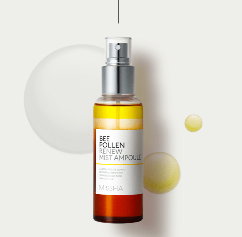 Amber and clear spray bottle of bee pollen renewing mist ampoule with silver nozzle on light background