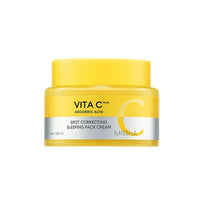 Yellow jar of brightening spot correcting sleeping mask cream with ascorbic acid on a white background