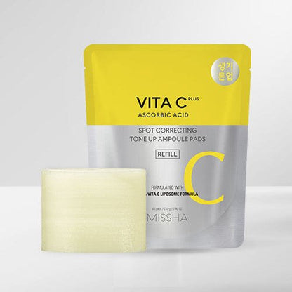 Yellow and silver refill pouch of brightening spot correcting ampoule pads with a visible textured pad on a white background