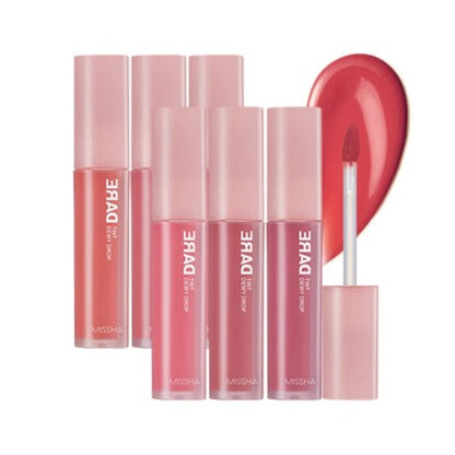 Six soft pink-tinted lip tints with clear containers and one open applicator showing dewy red gloss drop