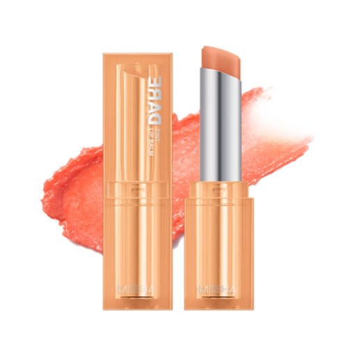 Coral-toned moisturizing lip balm stick with matching glossy beige-orange packaging against white background