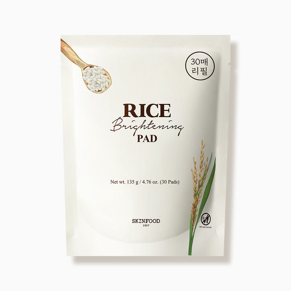 White refill pouch of brightening rice skincare pads featuring rice grain and stalk illustrations on plain background