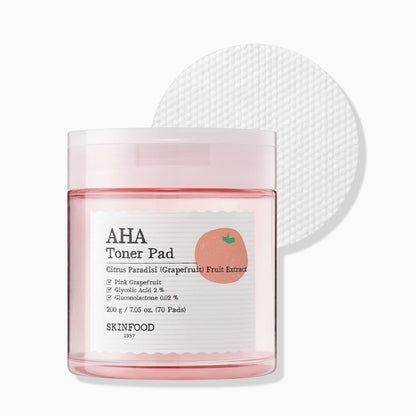 Clear jar of gentle exfoliating toner pads with pink grapefruit extract and textured cotton pad on white background