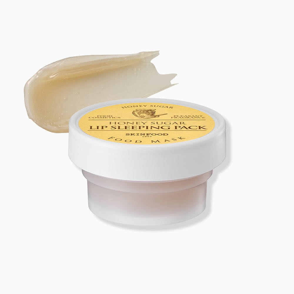 Small jar of hydrating honey sugar lip mask with creamy texture swatch above on white background