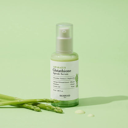 Bottle of light green brightening serum with asparagus extract and clear pump dispenser on pale green background