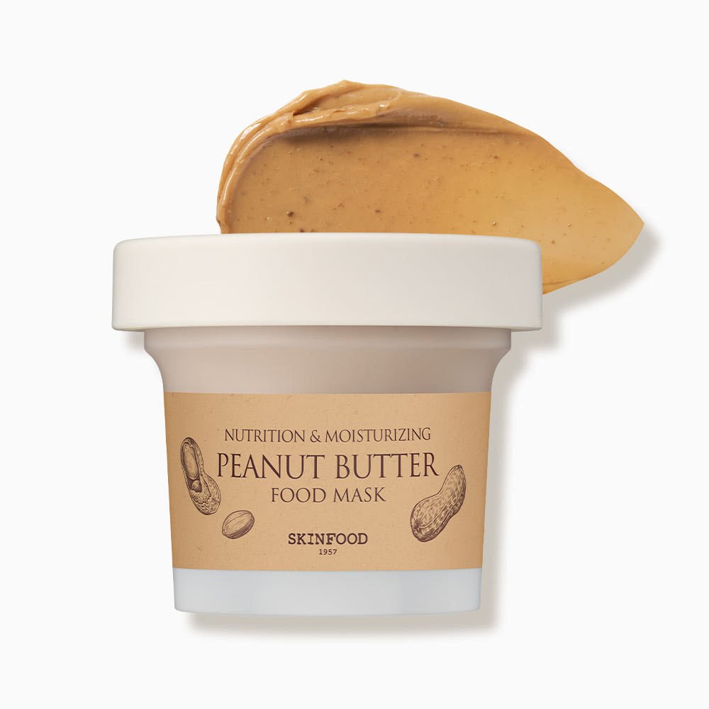 Jar of moisturizing peanut butter food mask with creamy texture scoop on white background