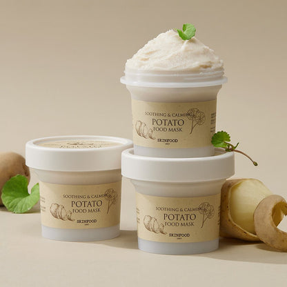 Three jars of soothing potato food mask with creamy texture and fresh green leaves on neutral background