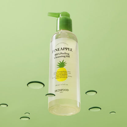Clear bottle of pineapple BHA peeling cleansing oil with green pump dispenser floating against pale green backdrop