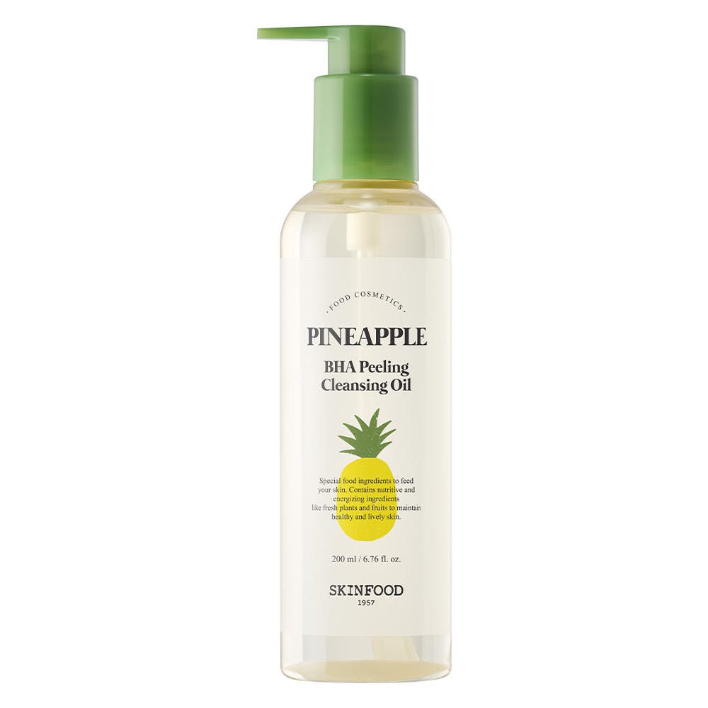 Clear bottle of gentle cleansing oil with green pump and yellow pineapple graphic for exfoliating skincare routine