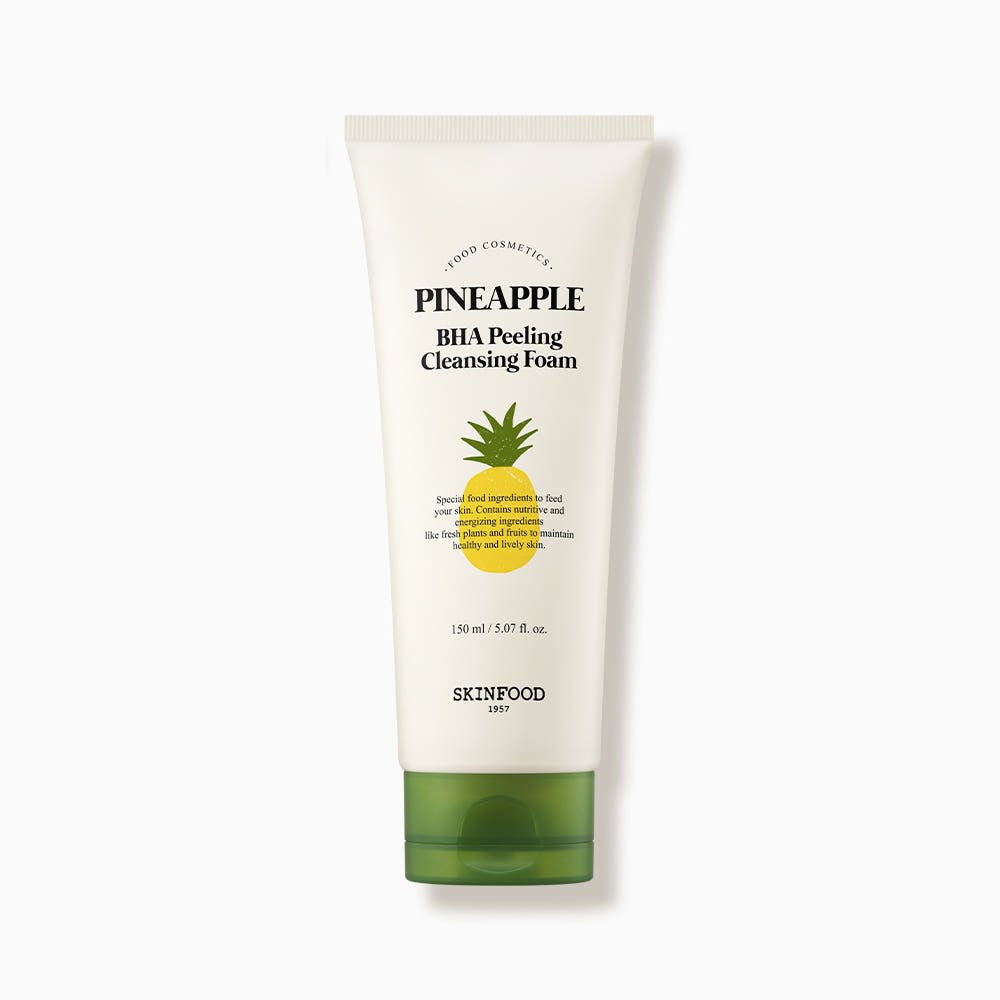 White tube of cleansing foam with green cap featuring pineapple graphic and exfoliating BHA formula text