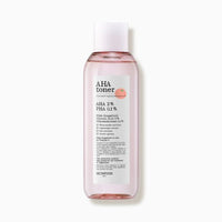 Clear pink liquid toner bottle labeled with exfoliating AHA and PHA acids for gentle skin renewal