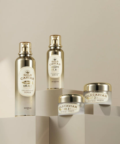Four SKINFOOD Gold Caviar Collagen Plus skincare products in elegant gold and white packaging on neutral geometric blocks