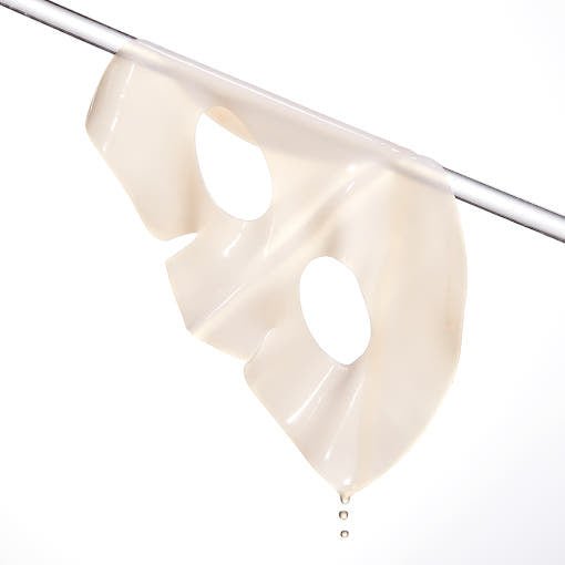 Translucent hydrogel sheet mask with eye cutouts dripping serum, highlighting brightening skincare benefits