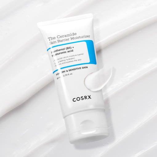 White tube of Ceramide Skin Barrier Moisturizer with cream swatch on white textured background emphasizing hydration boost